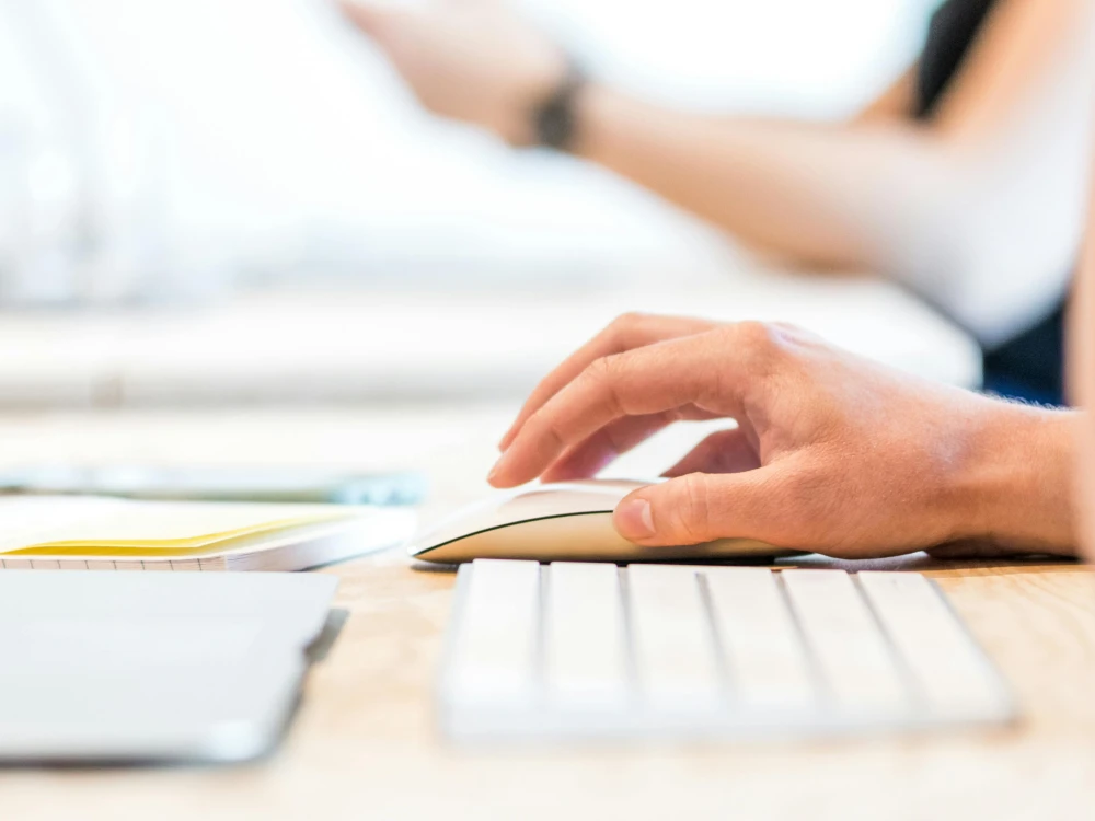 Person typing on a computer while completing a contact enquiry